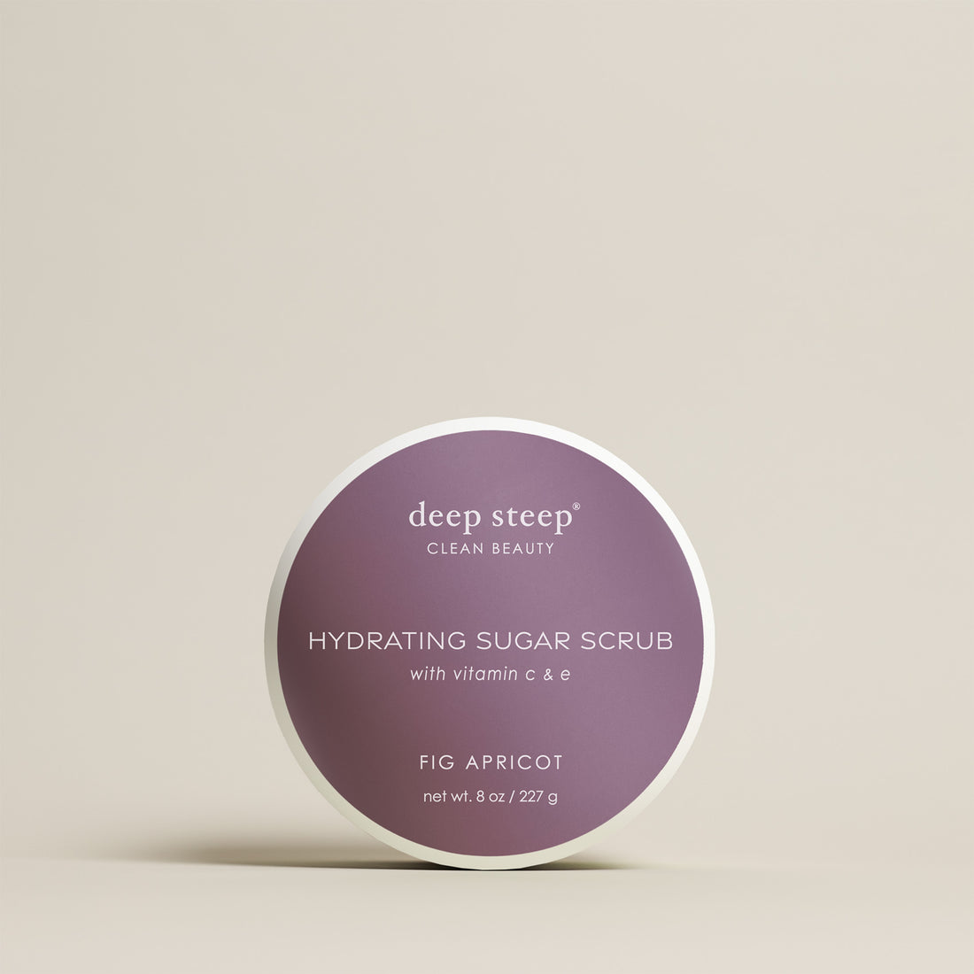 8 oz / 227 g Deep Steep Fig Apricot hydrating sugar scrub with vitamin C and E in a container on a beige background