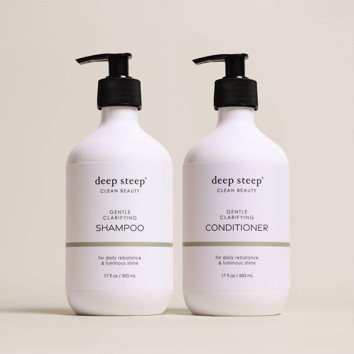 Two bottles of Deep Steep Gentle Clarifying Shampoo and Conditioner, 17 fl oz bottles with pumps, on a beige background