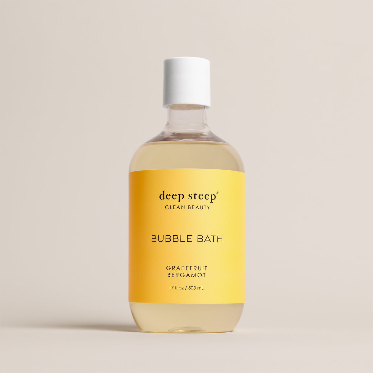 Deep Steep Grapefruit Bergamot Bubble Bath, 17 fl oz hypoallergenic bottle with a yellow label on a neutral background