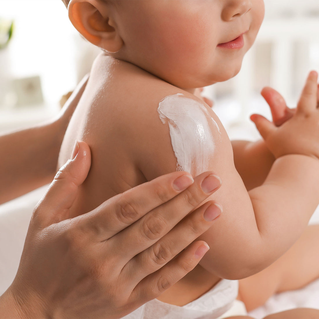 deep steep 3 in 1 Face, Body, Hand Cream for baby, mother rubbing onto baby