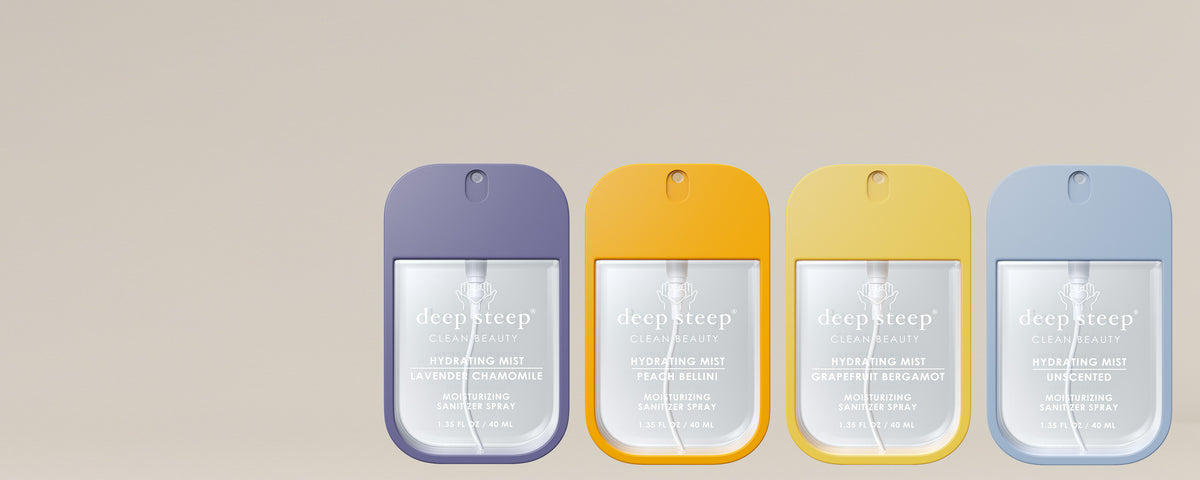 Four Deep Steep Hydrating Mist Sanitizer Sprays in Lavender Chamomile, Peach Bellini, Grapefruit Bergamot, and Unscented, lined up on a beige background.