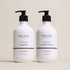 Two bottles of Deep Steep Coconut Oil High Shine Shampoo and Conditioner, 17 fl oz bottles with pumps, on a beige background