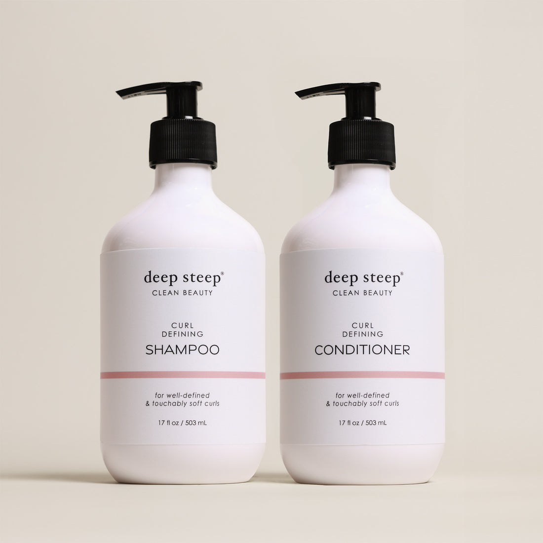 Two bottles of Deep Steep Curl Defining Shampoo and Conditioner, 17 fl oz bottles with pumps, on a beige background