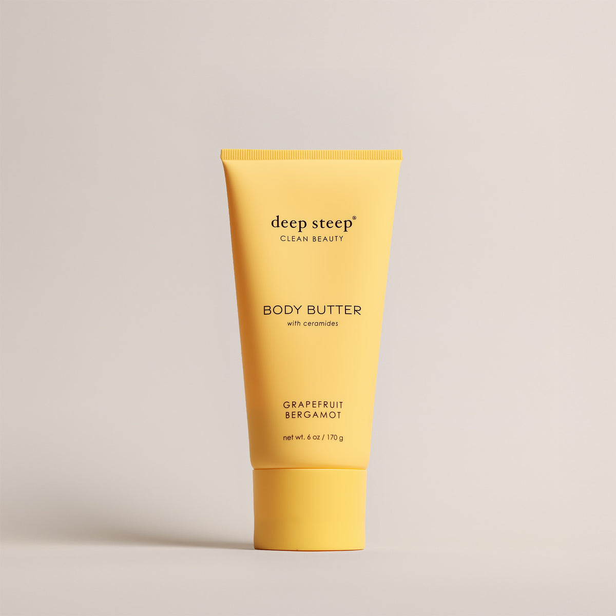 Deep Steep Grapefruit Bergamot Body Butter, 6 oz tube, featuring ceramides on a beige background