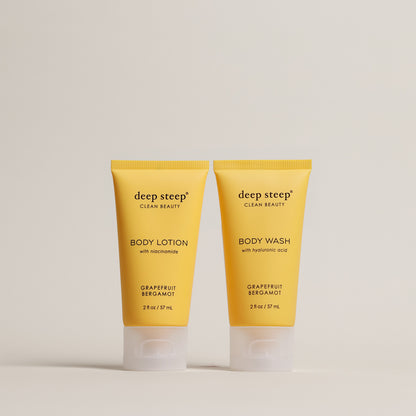 Two tubes of Deep Steep Grapefruit Bergamot Body Lotion and Body Wash, 2 fl oz tubes, on a beige background