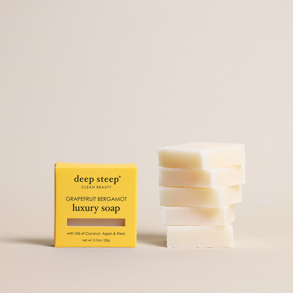 Deep Steep Grapefruit Bergamot luxury soap bar, 0.7 oz net weight, next to its packaging box made with coconut, argan, and shea oils, 5 Pack