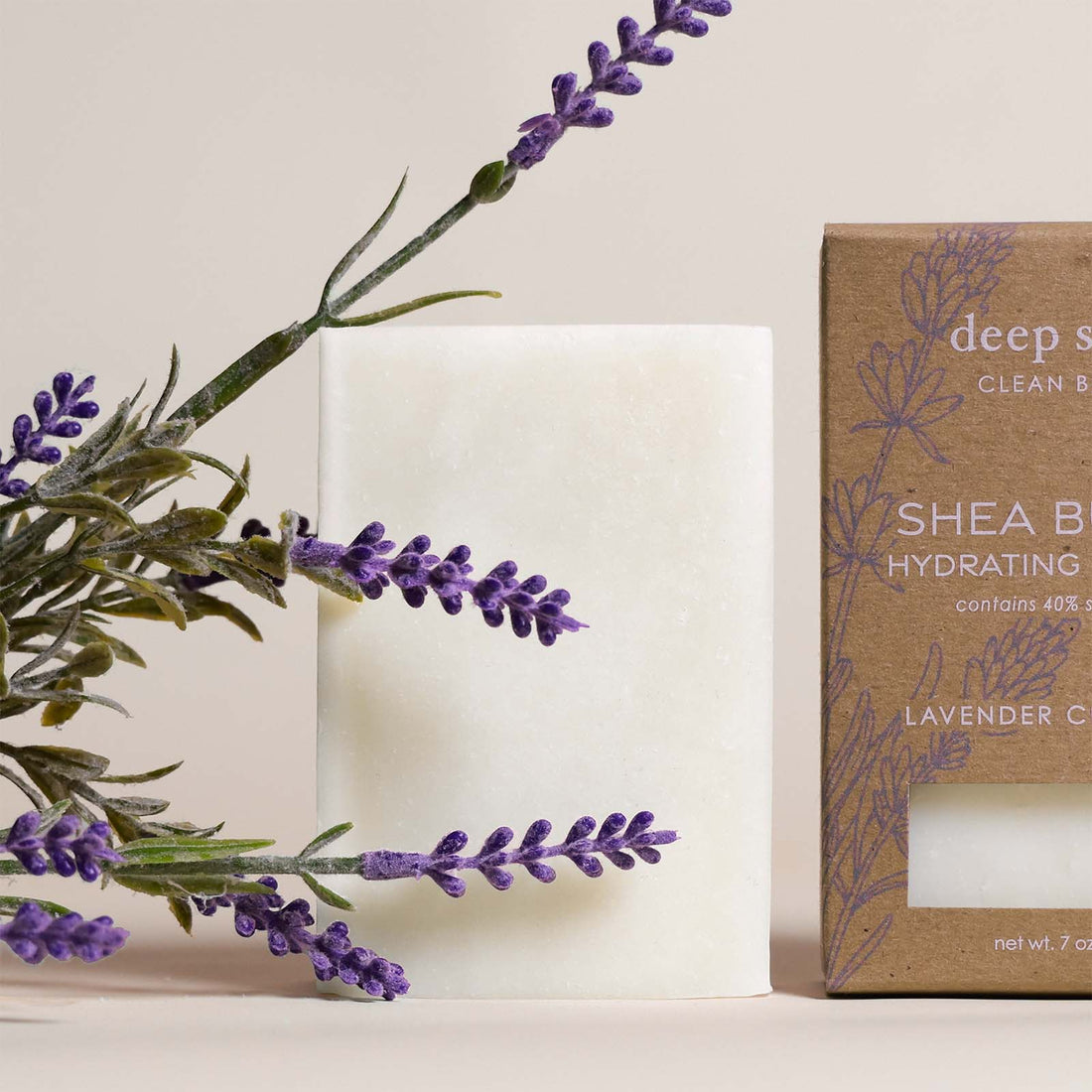 7 oz Deep Steep Lavender Chamomile hydrating bar soap containing 40% shea butter alongside lavender sprigs on a neutral background