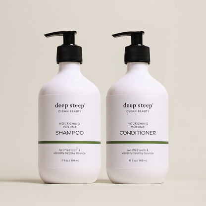 Two bottles of Deep Steep Nourishing Volume Shampoo and Conditioner, 17 fl oz bottles with pumps, on a beige background