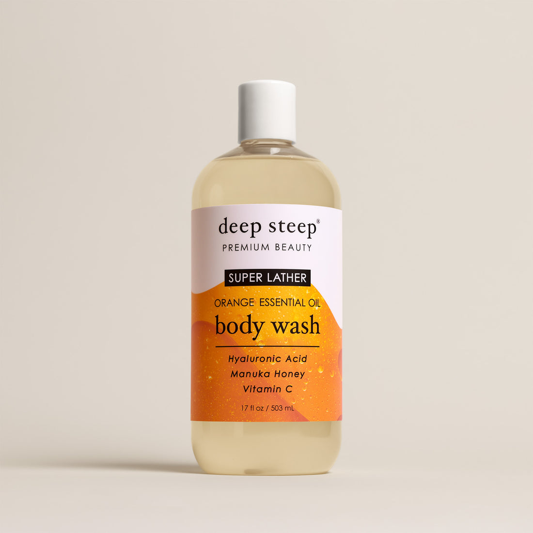 Deep Steep Orange Essential Oil Body Wash, 17 fl oz bottle with a white cap, featuring hyaluronic acid, manuka honey, and vitamin C on a beige background