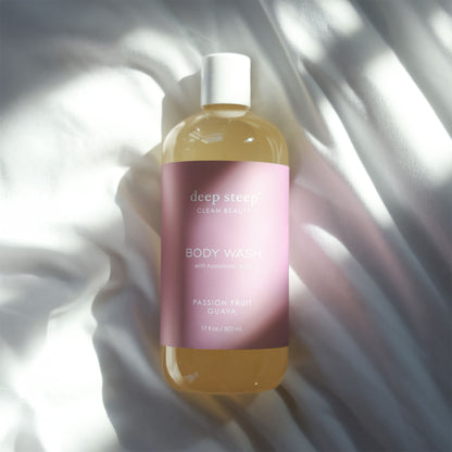Bottle of Deep Steep Passion Fruit Guava Body Wash on a light fabric background