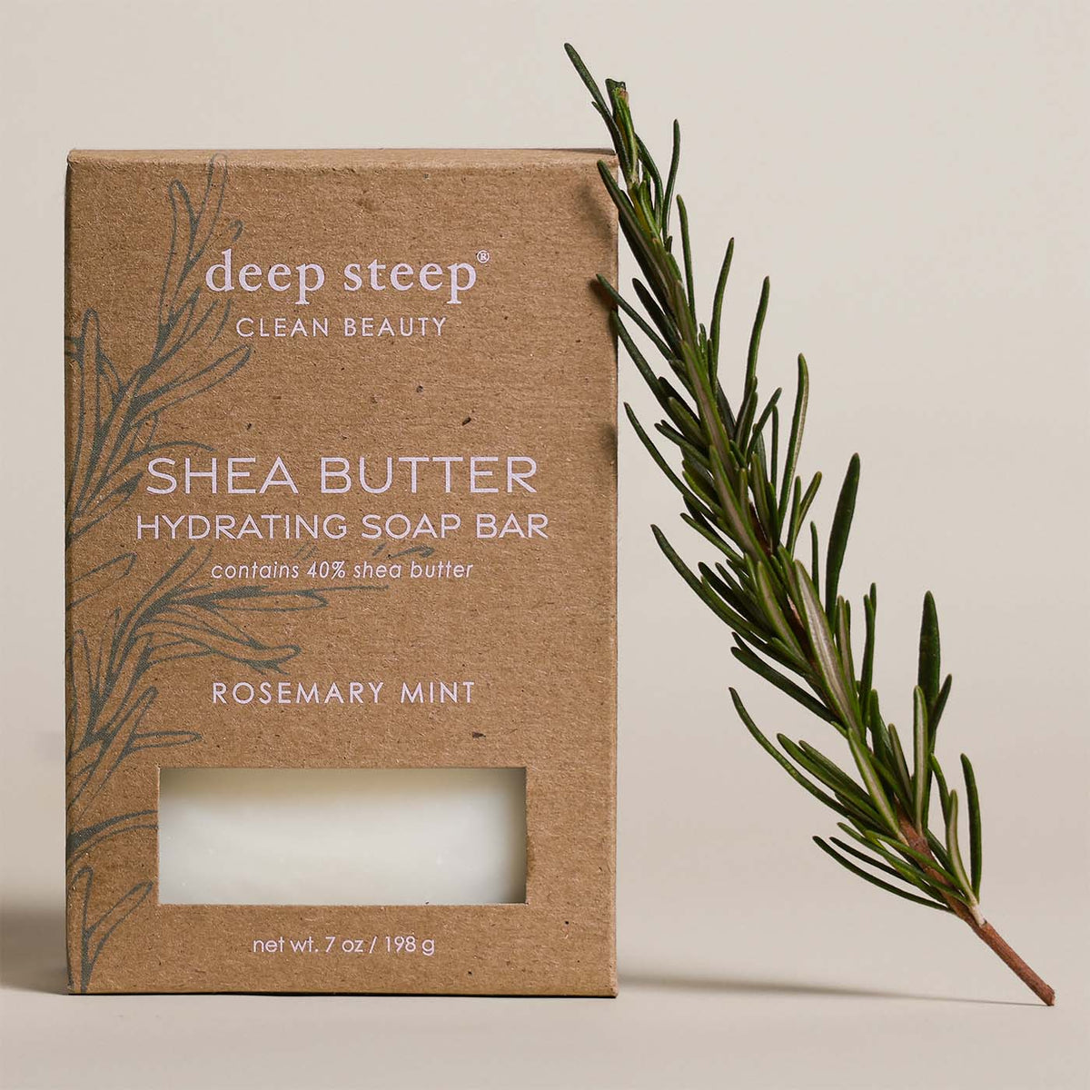 7 oz Deep Steep Rosemary Mint hydrating bar soap containing 40% shea butter alongside a fresh rosemary sprig on a beige background