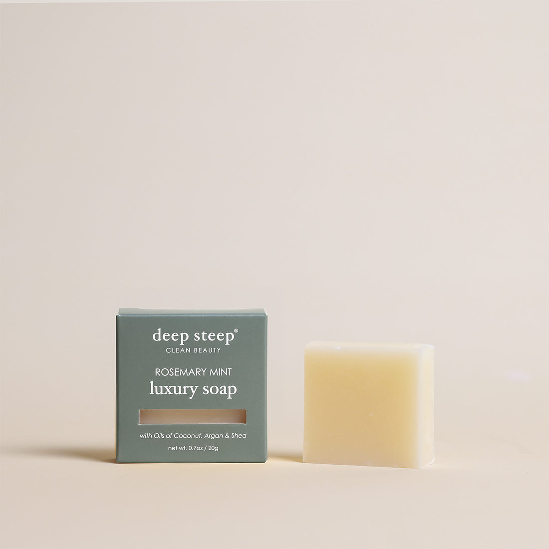 Deep Steep Rosemary Mint luxury soap bar, 0.7 oz net weight, next to its packaging box made with coconut, argan, and shea oils