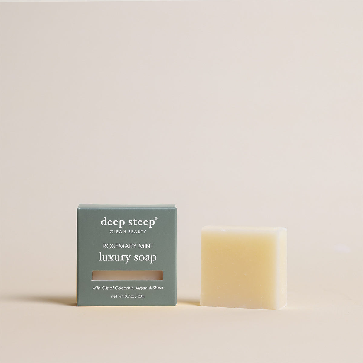 Deep Steep Rosemary Mint luxury soap bar, 0.7 oz net weight, next to its packaging box made with coconut, argan, and shea oils