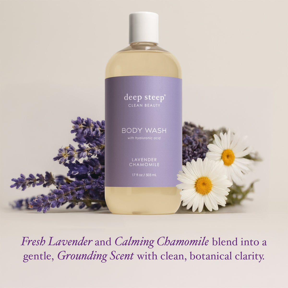 A bottle of deep steep Clean Beauty body wash with lavender chamomile scent, styled with fresh lavender sprigs and chamomile flowers on a light beige background with descriptive text below.