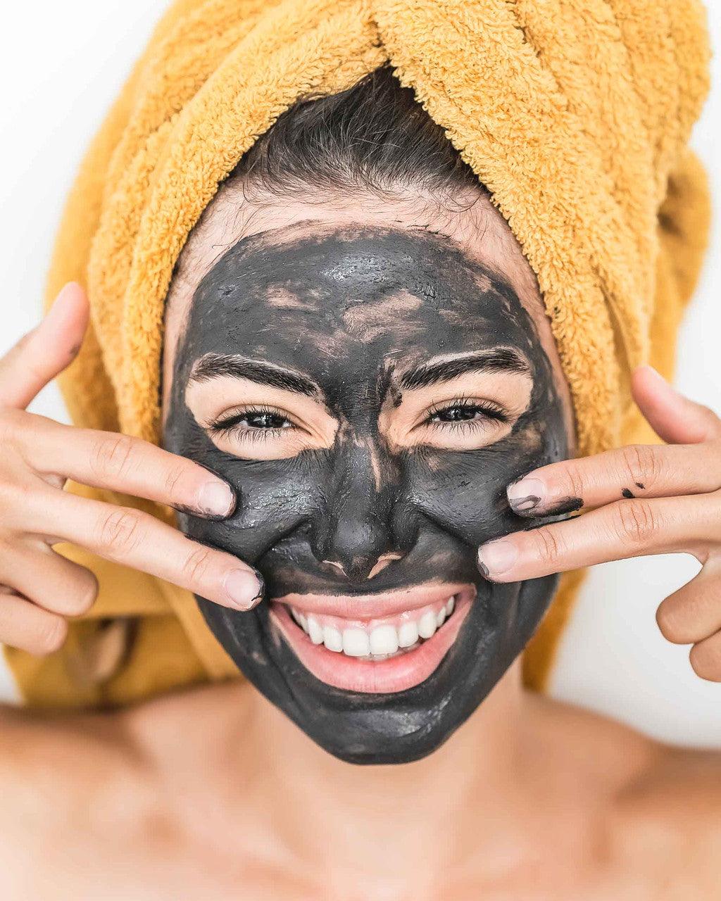 Woman With Deep Steep Charcoal Face Mask
